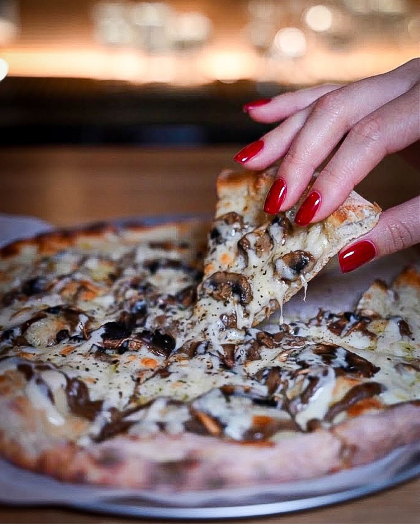 A wood-fired mushroom and truffle pizza with melting cheese