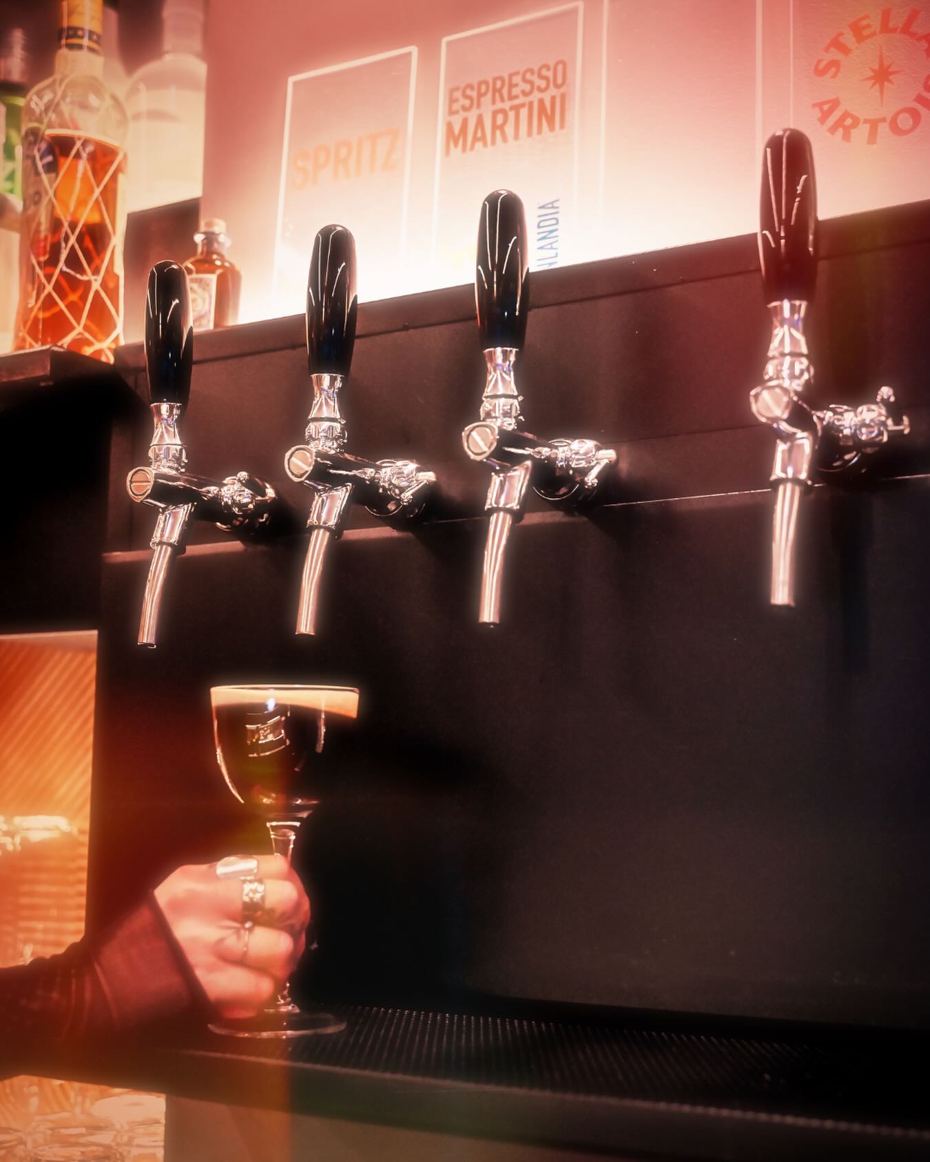A dark, elegant cocktail poured at the Lowkey bar taps